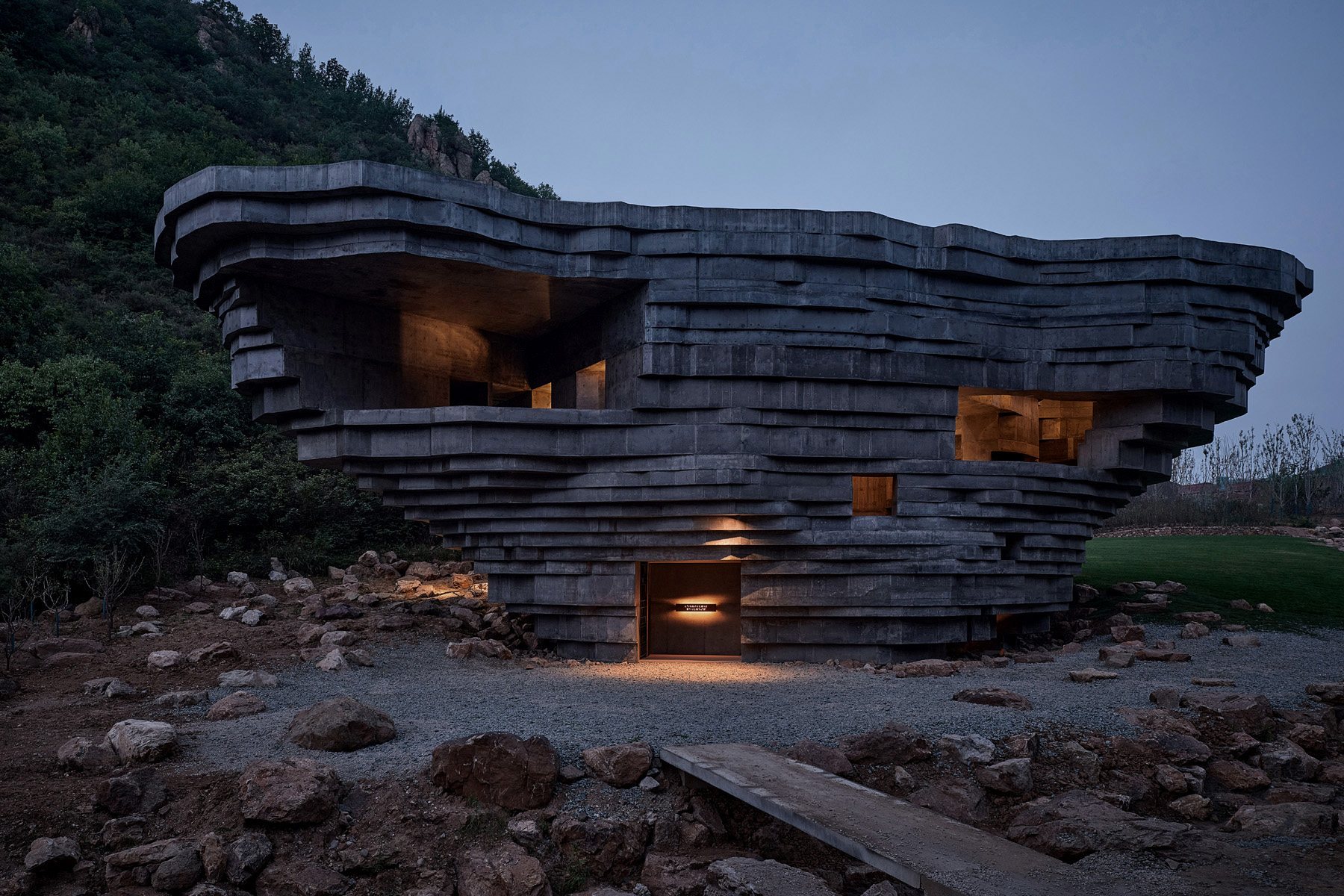 The stratified concrete shell lit from within at night